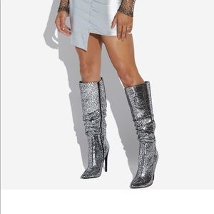 A slouchy stiletto boot featuring a pointed toe and zipper closure.